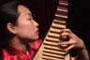 Liu Fang plays pipa, four-stringed guitar